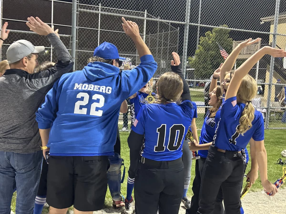 Bryan's youth team celebrating together under the lights