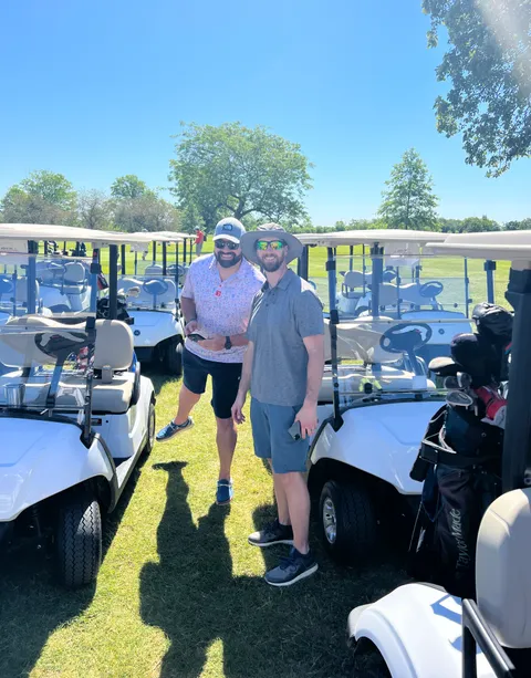 Two golfers at the cart line before heading out