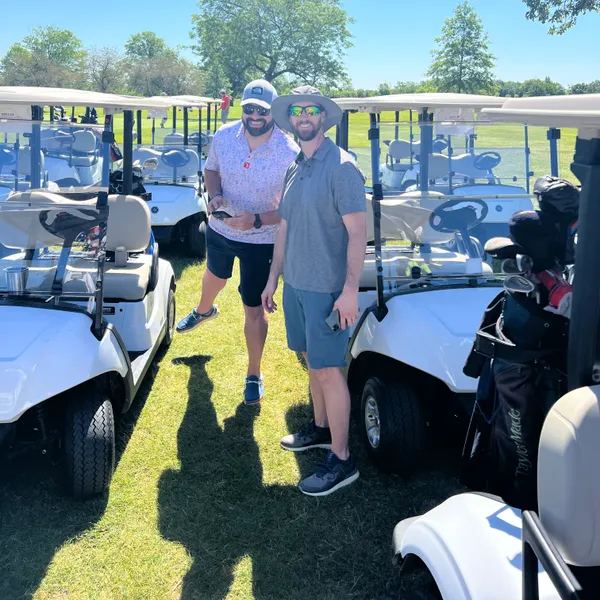 Two golfers at the cart line before heading out