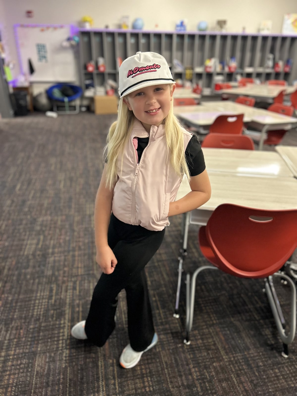 A young supporter wearing a white MOments hat at school
